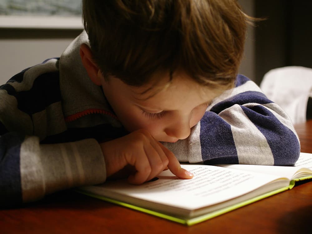 michal-parzuchowski-BPXSTl_HBhk-unsplash copy Boy reading