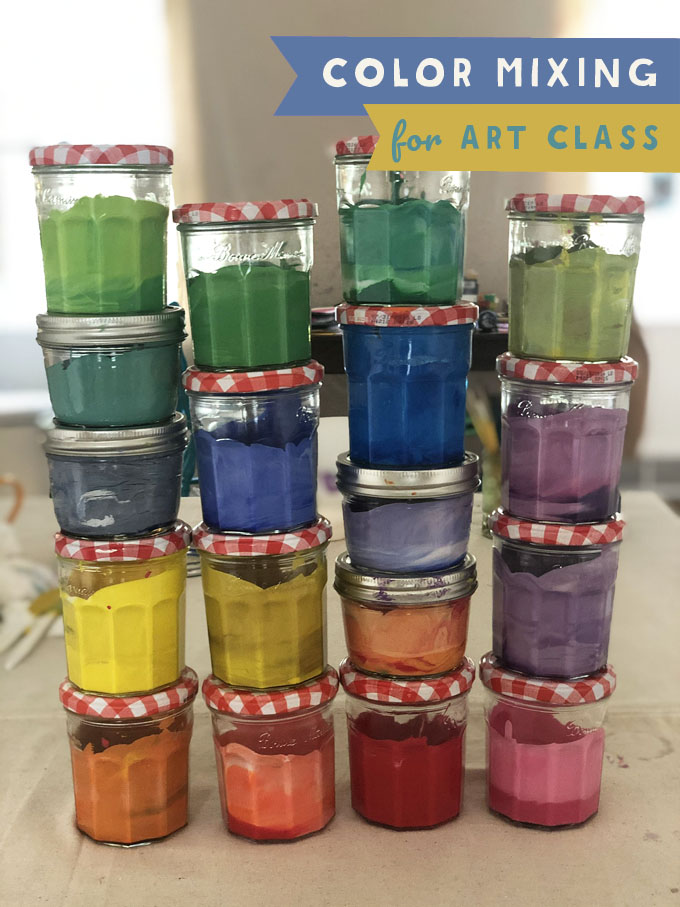 Jars of tempera paint on a table in an array of hand-mixed colors.