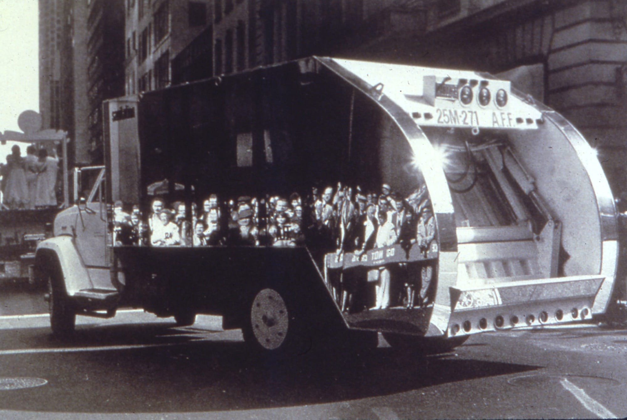 a black and white photo of a mirrored garbage truck