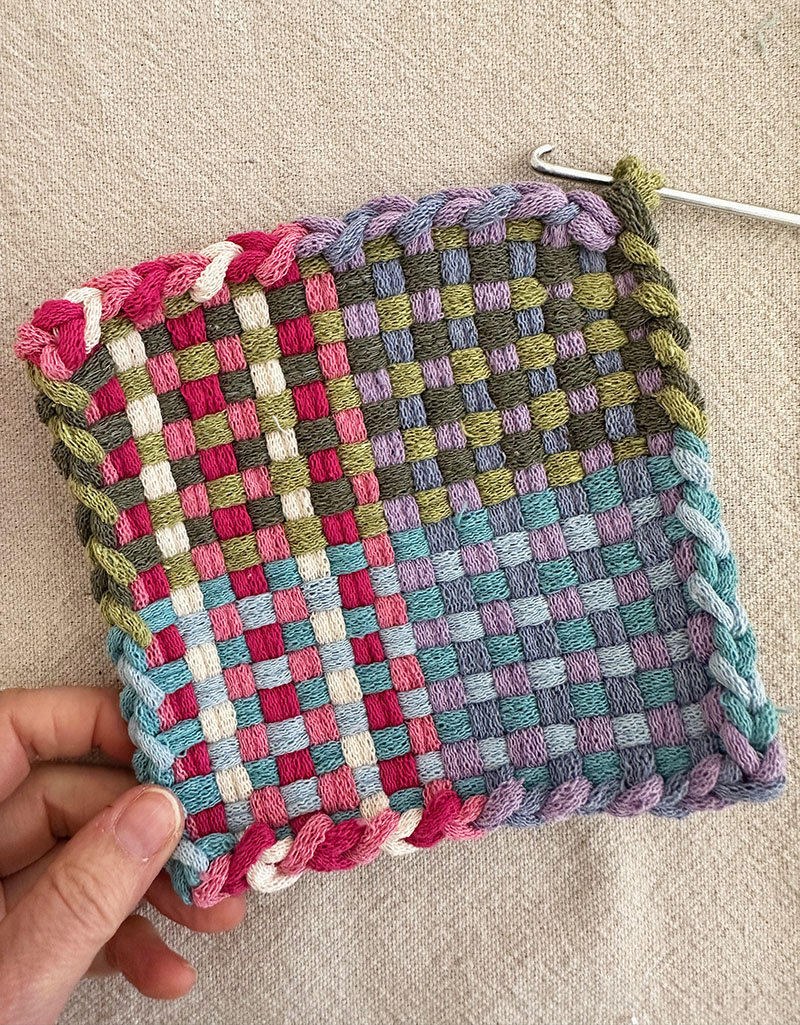 When you get to the end and you have the last loop left on the weaving hook, leave it on as you pull on the sides to even them out.