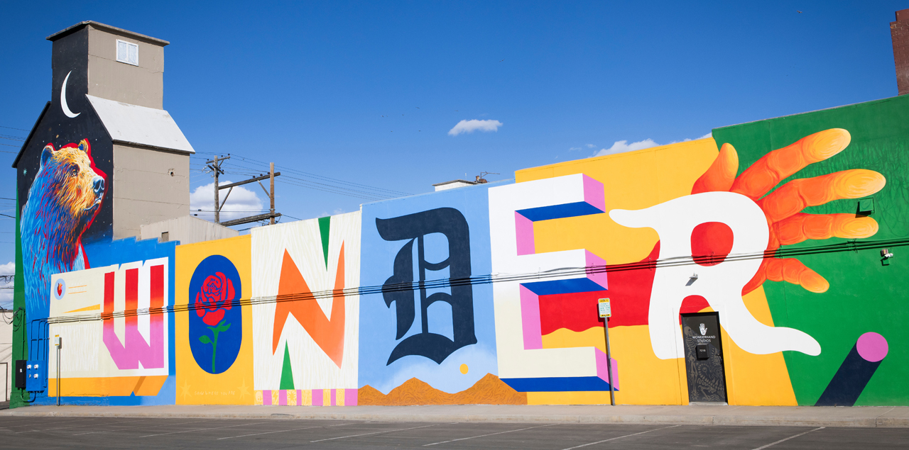 A coloful mural depicting a Bear overlooking the word Wonder