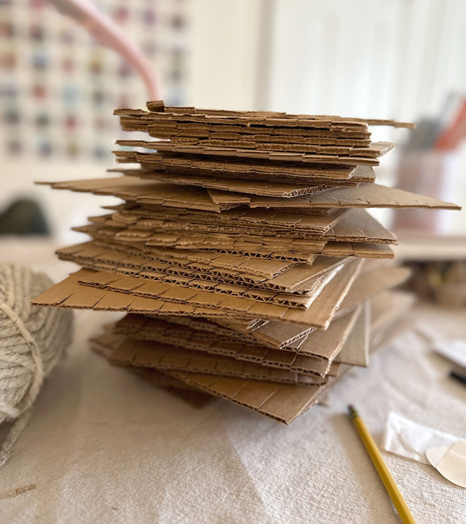 A stack of cardboard looms on a table.